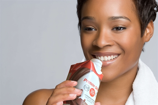 African American women drinking a protein shake.