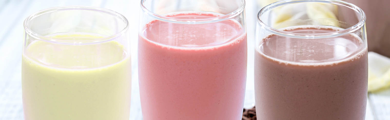 Three shakes lined up.  Starting on the left, they are vanilla, strawberry and chocolate.